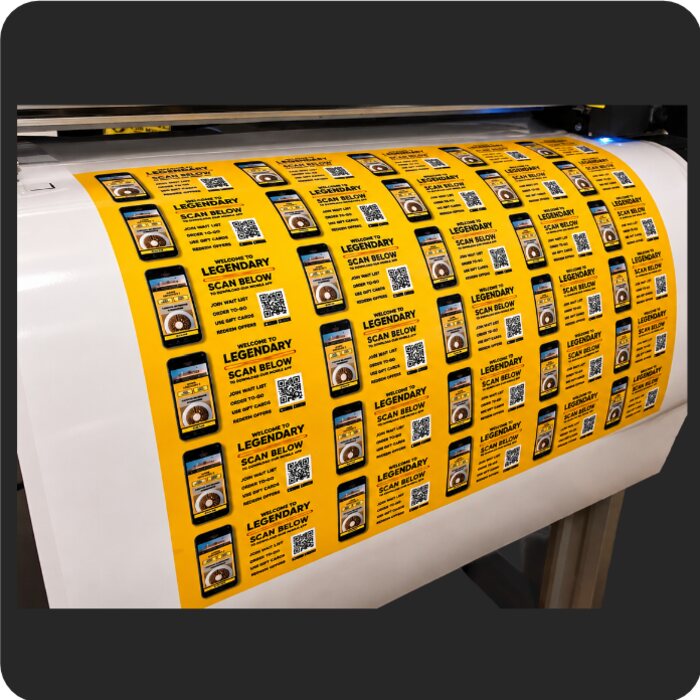 Sheets of custom stickers coming off the printer